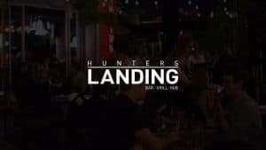 Vibrant Toronto bar scene at Hunter's Landing with lively groups enjoying drinks and socializing.